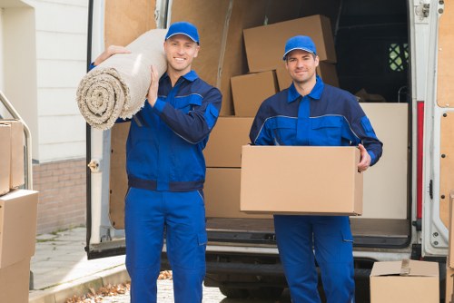 Furniture removal team handling a move in a Hammersmith residential street