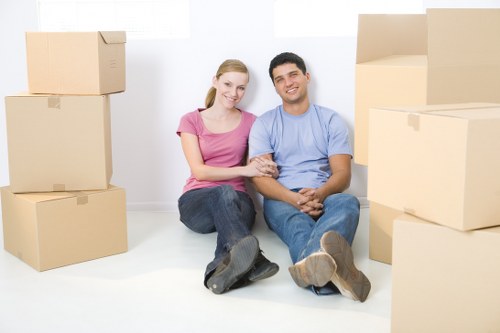 Packed office equipment and labelled moving crates for a business move